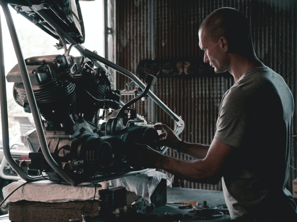 Man repairing an engine in a workshop